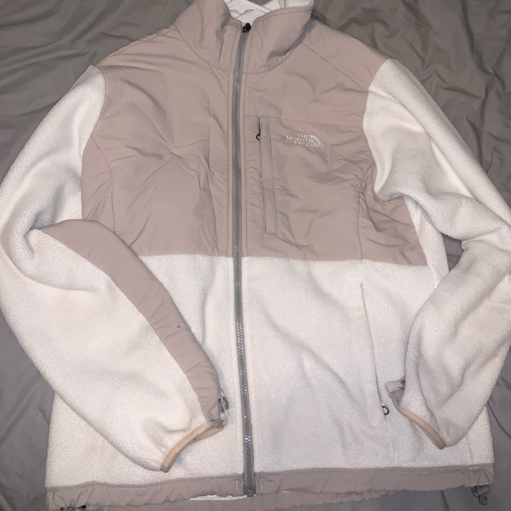 Tan and white north face jacket